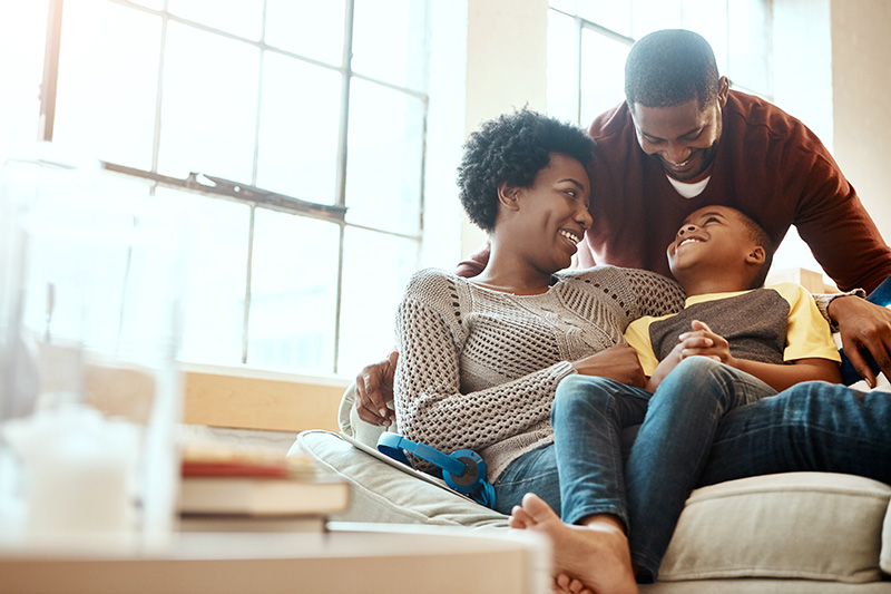 couple and child on sofa in home