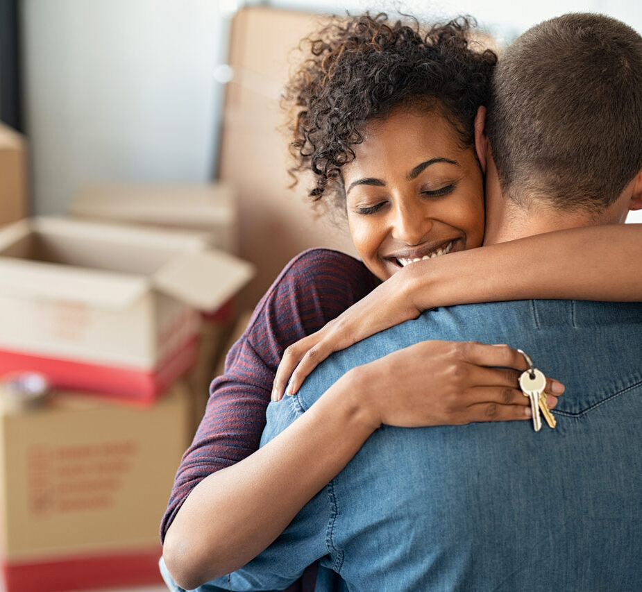 a couple with keys moved into a new home